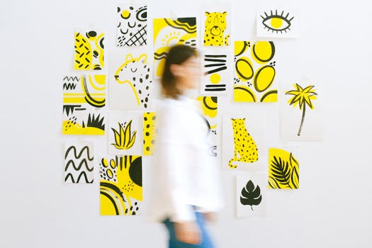 A woman walks past a wall with vibrant yellow art posters, adding dynamic motion to the creative space.